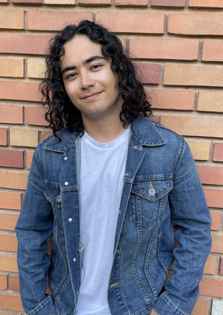 Joseph Jacobson smiling infront of a brick wall